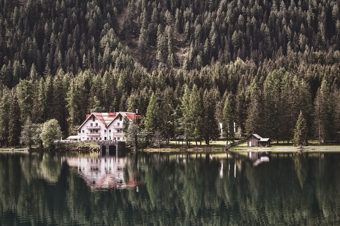 4K view of Antholzer See with trees and reflection