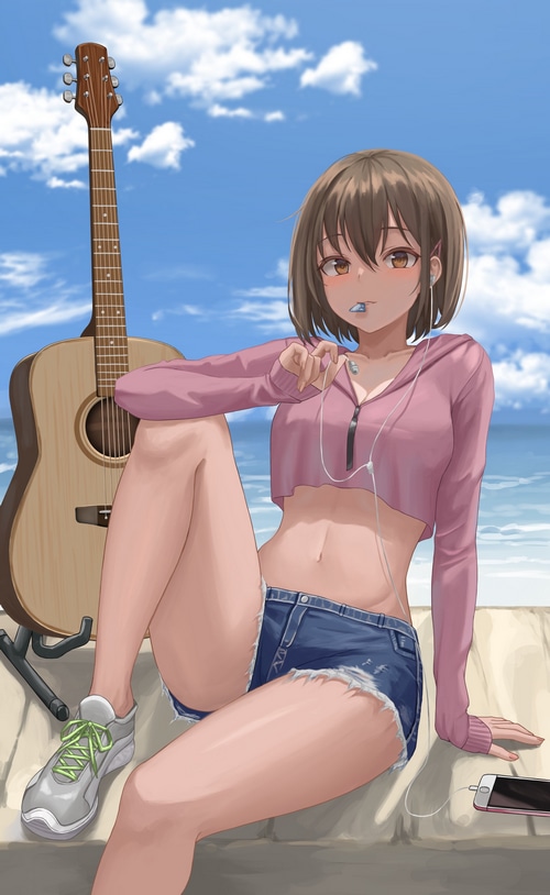 Girl with guitar and headphones at the beach