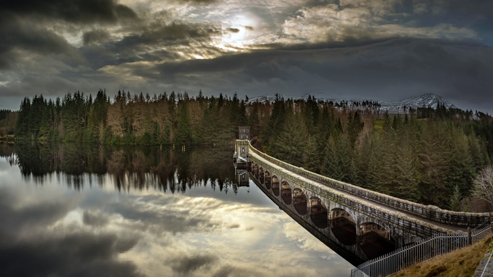 4K Dam with Reflection and Forest Landscape