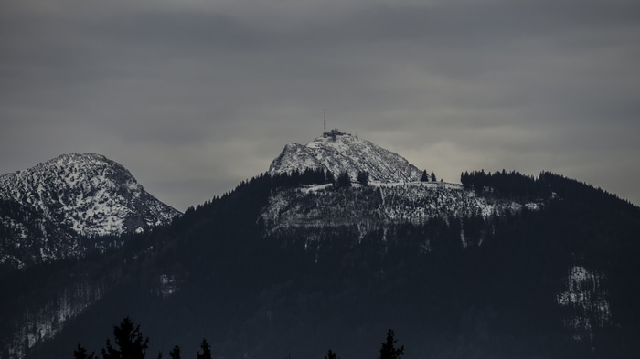 Snow-covered mountains with trees and overcast sky