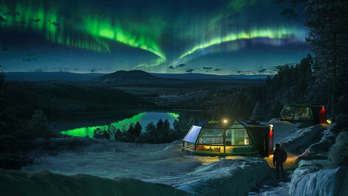 Igloos under the Aurora Borealis over a snowy landscape