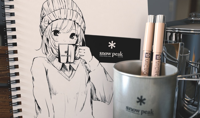 Anime girl with Snow Peak mug and pens