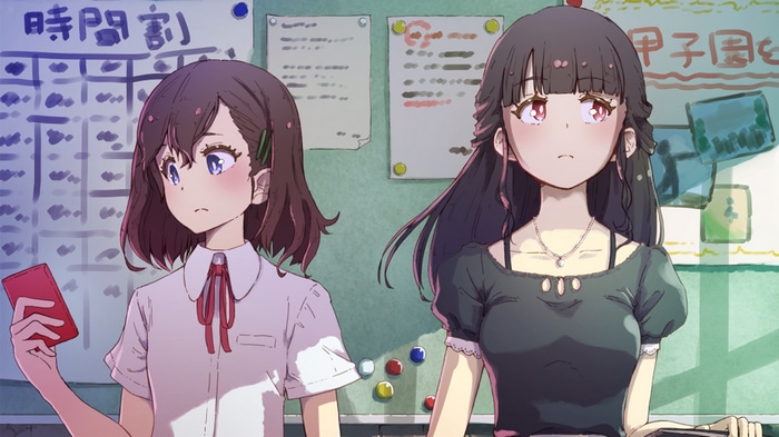 Two girls in a classroom with a schedule board