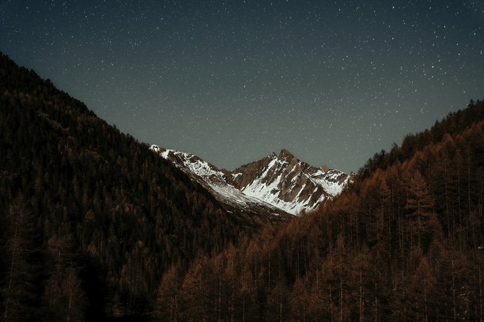 Mountains under a starry night sky