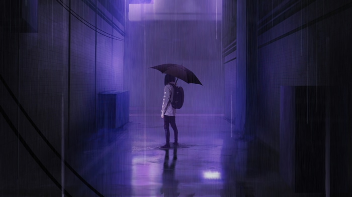Person with umbrella in the rain at night