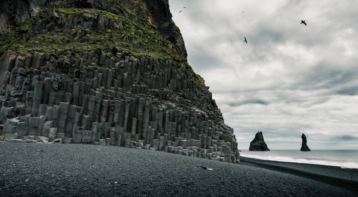 Basalt columns on a black sand beach in Iceland