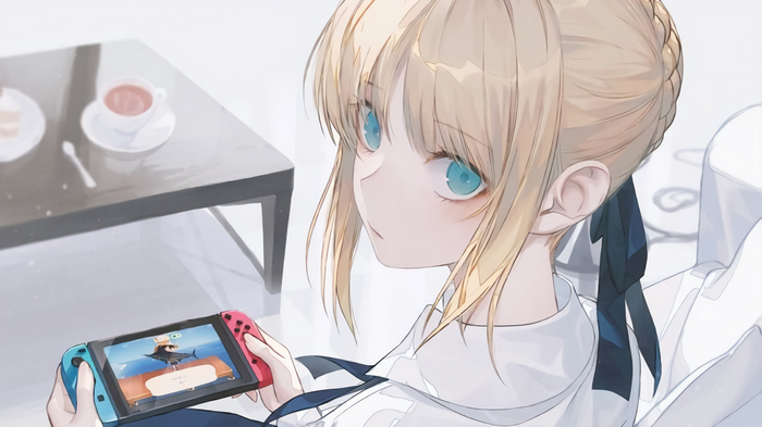 Saber playing Nintendo Switch with tea on table
