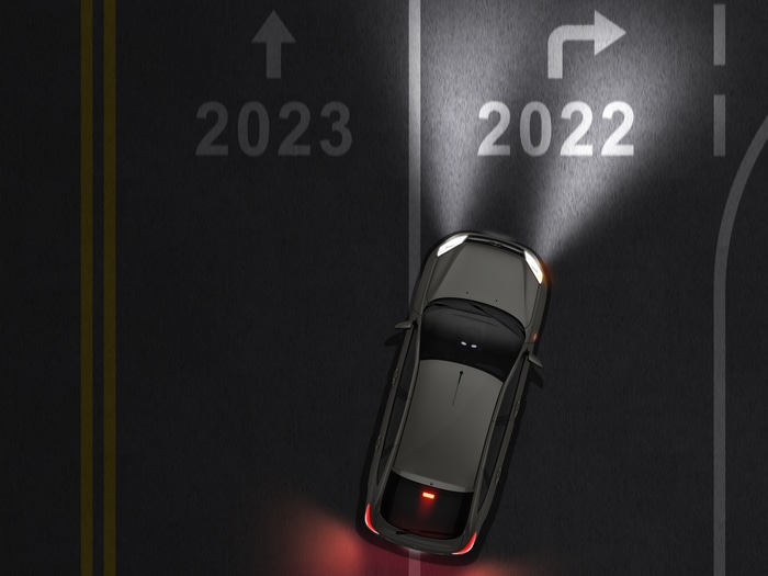 Car driving from 2022 to 2023 on road