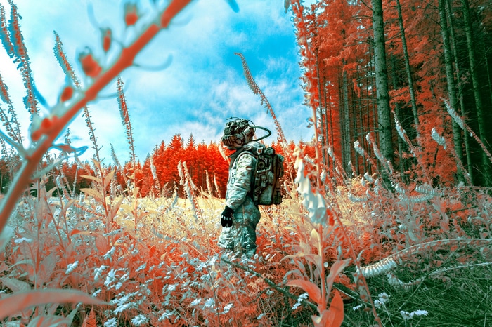 Man in spacesuit in a surreal forest