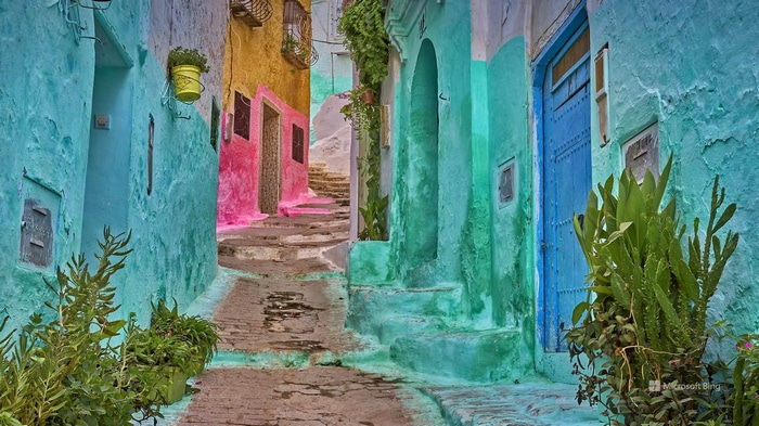 Colorful alleyway with turquoise and pink walls and stairs
