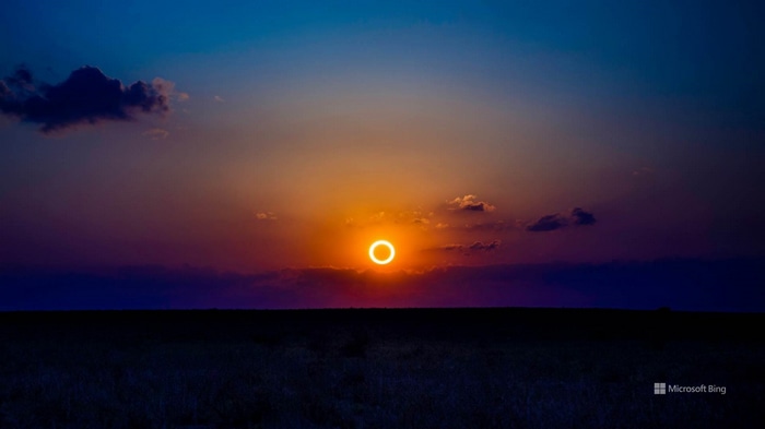 Annular solar eclipse over a dark landscape