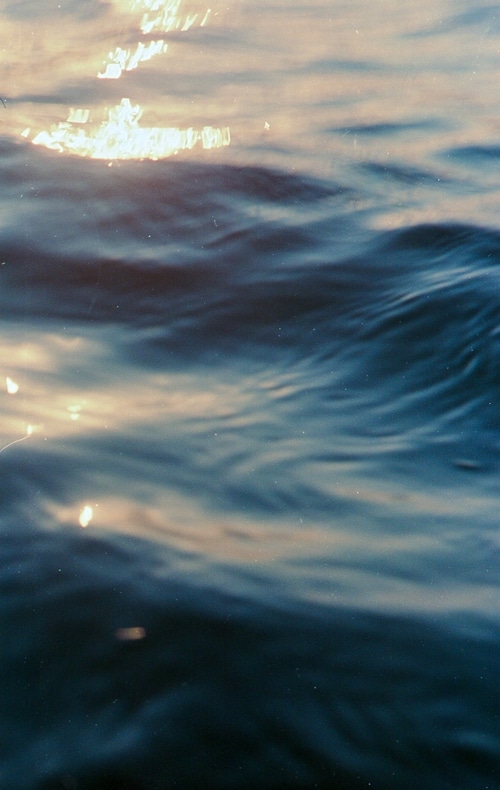 Sunlight reflecting on rippling blue water