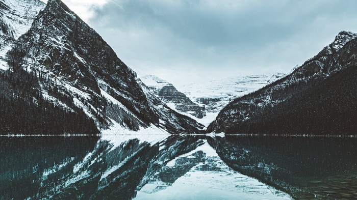 4K snow-capped mountains reflected in a lake