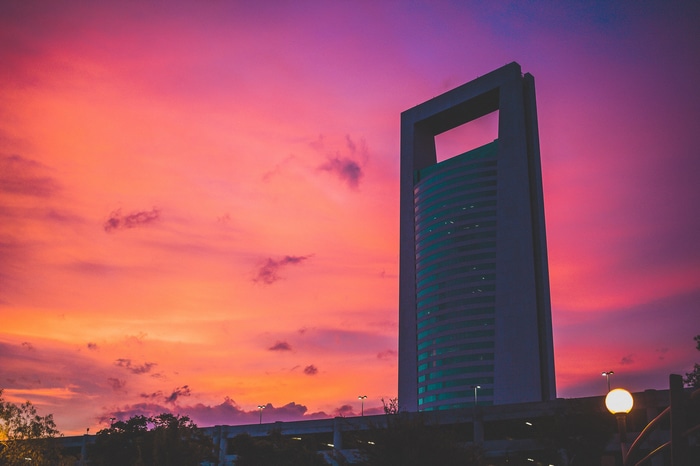 Modern building against a vibrant sunset sky