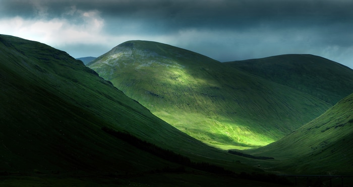 4K Scottish Highlands landscape with sunlit hills
