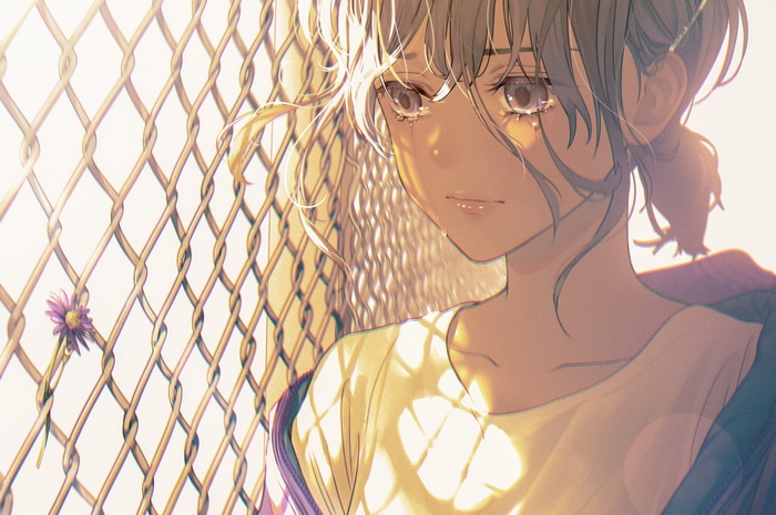 Girl crying by a chain-link fence