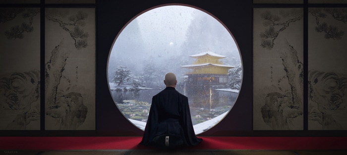 Monk meditating at Kinkaku-ji in the snow