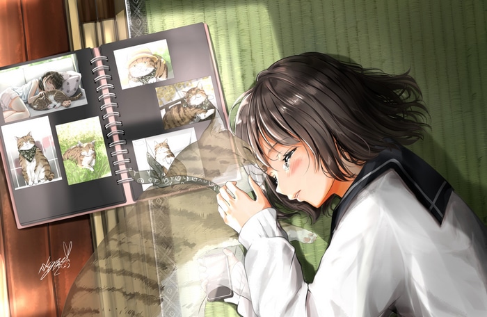Girl in school uniform looking at cat photos