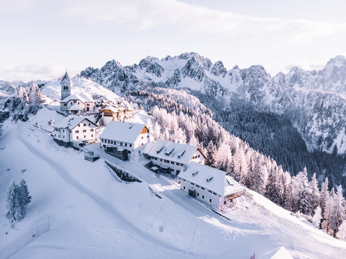 4K aerial view of a snowy mountain village in the Alps