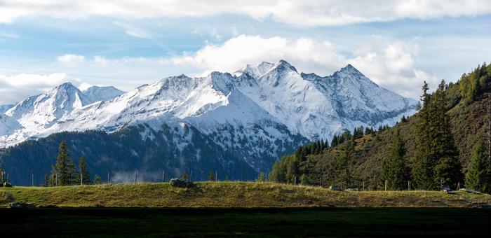 4K snowy mountain landscape with forest and hills