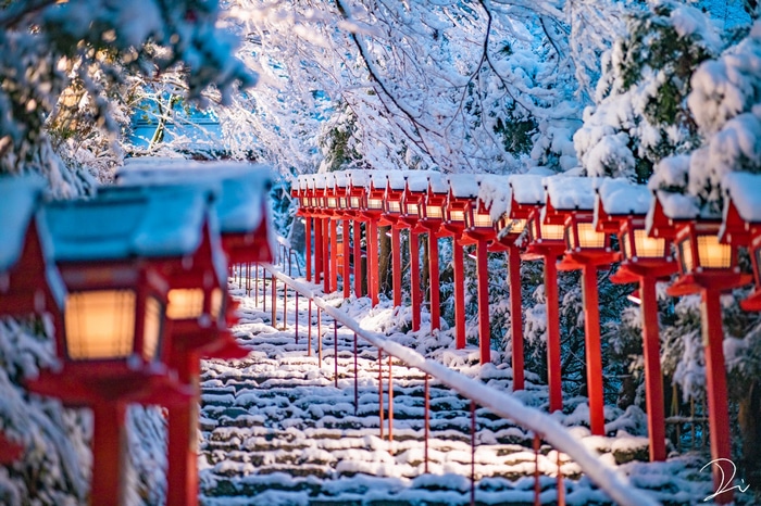 Snow-covered steps with red lanterns in Japan
