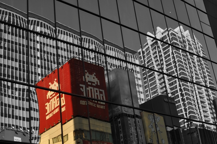 Reflection of Akihabara buildings on a glass facade