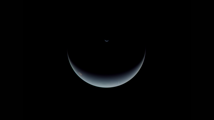 Neptune and its moon in space