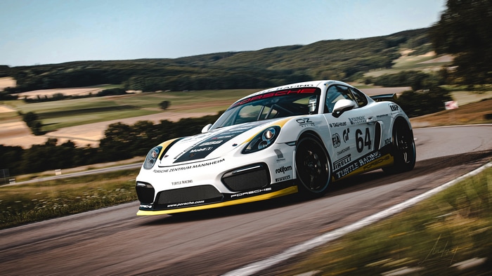 Porsche Cayman GT4 race car on a track