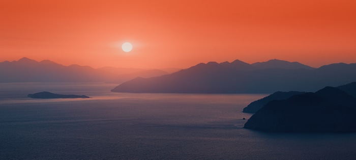 4K sunset over mountains and sea
