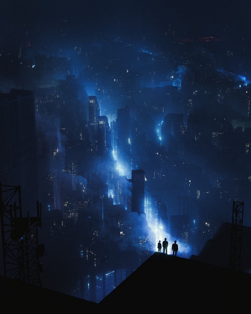 Three people stand on a rooftop overlooking a futuristic city at night.