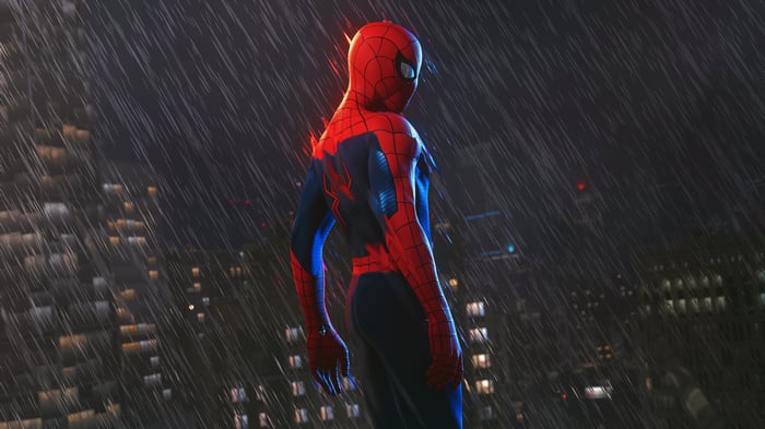 Spider-Man standing in the rain at night