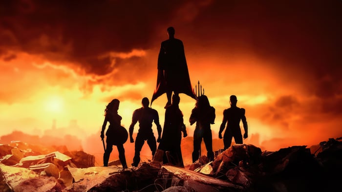 Justice League Silhouettes Against Fiery Sky