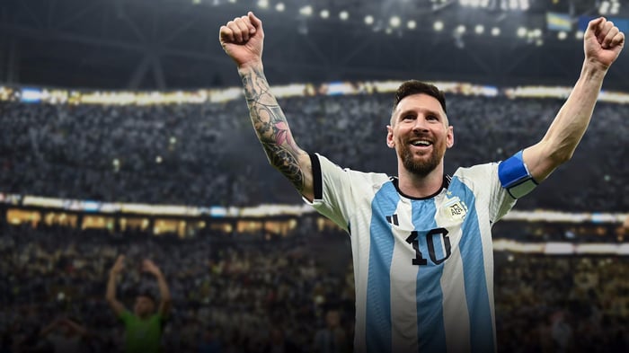 Lionel Messi celebrates with arms raised