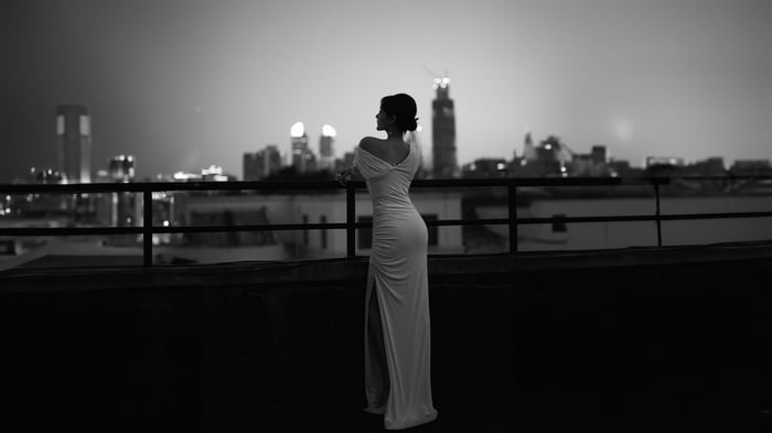 Asian girl in a white dress on a rooftop at night