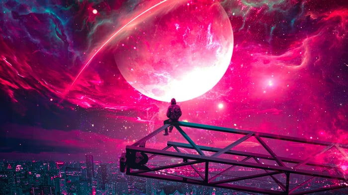 Person sitting on a platform overlooking a city under a pink nebula