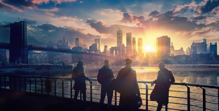Payday 3 characters on a waterfront at sunrise
