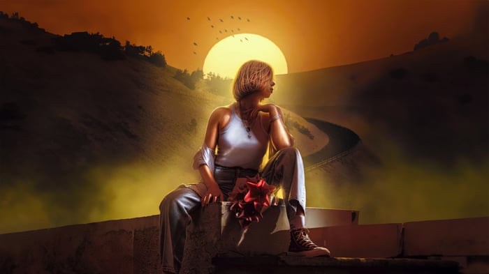 Girl with red flower at sunset