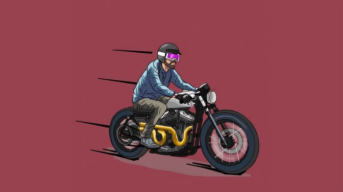 Man riding a cafe racer motorcycle