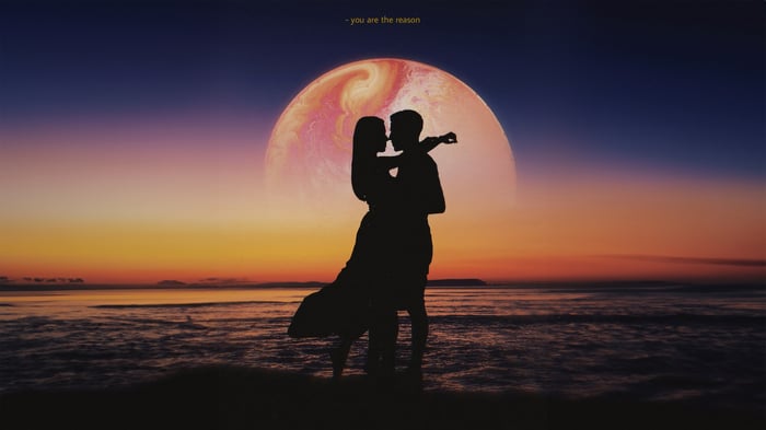 Couple Silhouetted Against a Planet at Sunset