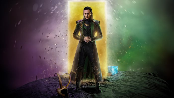 Loki stands before a glowing portal with the Tesseract