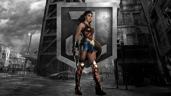 Wonder Woman in front of Justice League logo