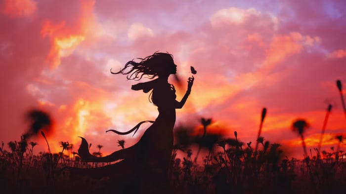 Girl and Butterfly in a Field at Sunset