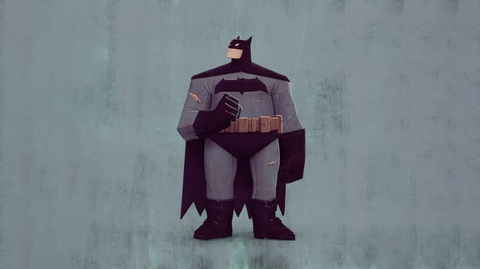 Batman standing against a textured wall