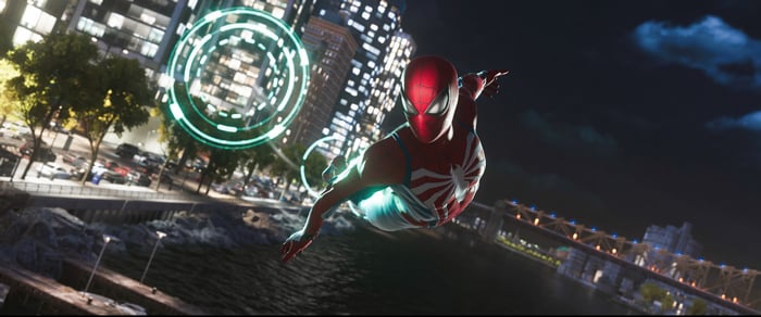 Spider-Man swings through a city at night
