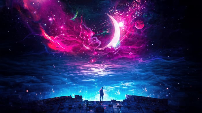 Man standing on ruins looking at colorful galaxy