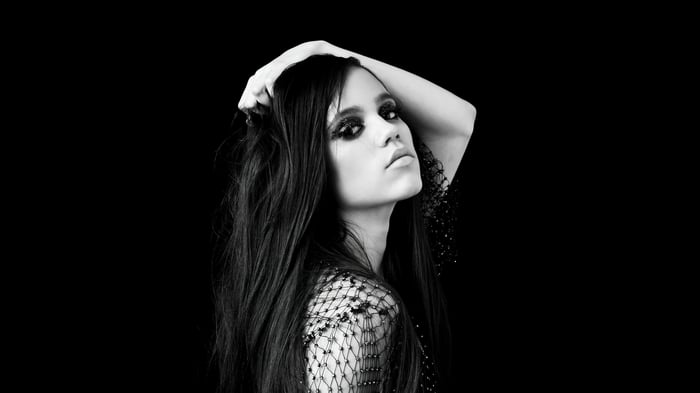 Jenna Ortega with dark eye makeup and mesh top