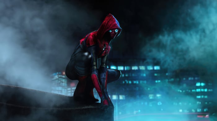 Spider-Man in a hooded suit crouches on a rooftop