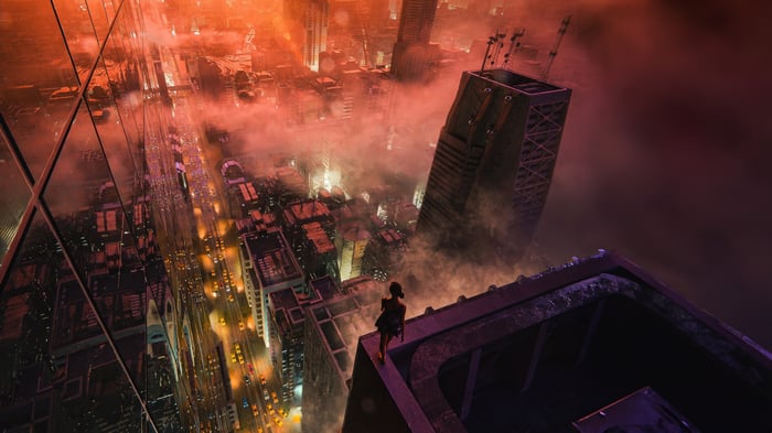 Girl on edge of skyscraper overlooking foggy city