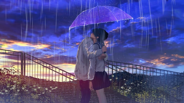 Couple Embraced by Rain Under Umbrella