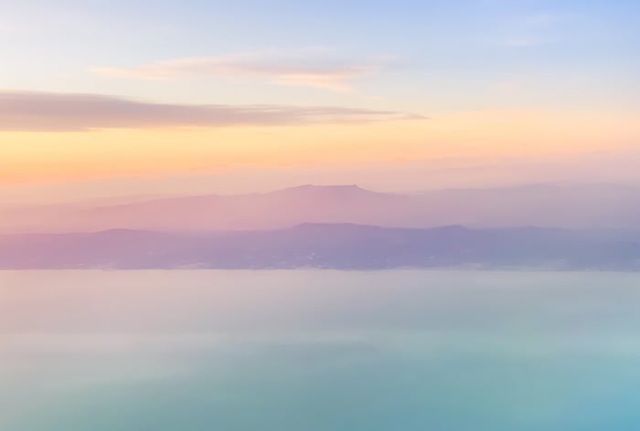 Mountains and water at sunset with pastel sky